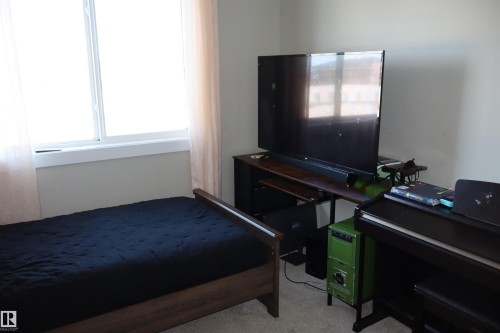 Bedroom featuring light colored carpet - 9760 - 107 Street, Westlock, AB - Indoor Photo Showing Bedroom