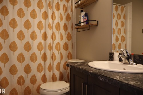 Bathroom with vanity and a shower with curtain - 9760 - 107 Street, Westlock, AB - Indoor Photo Showing Bathroom