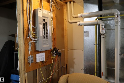 Utility room featuring electric panel and heating unit - 9760 - 107 Street, Westlock, AB - Indoor Photo Showing Basement