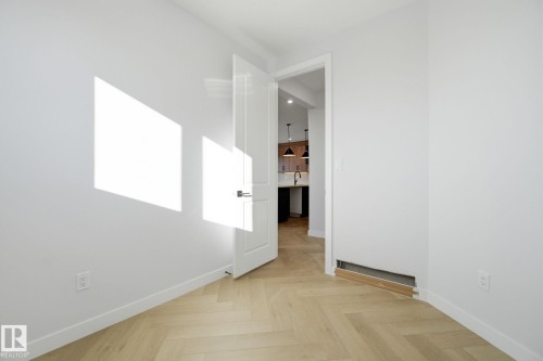 Unfurnished room featuring parquet floors and baseboards - 17108 2 Street, Edmonton, AB - Indoor Photo Showing Other Room