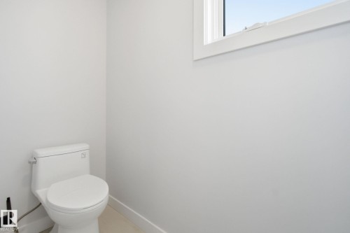 Bathroom with toilet and baseboards - 17108 2 Street, Edmonton, AB - Indoor Photo Showing Bathroom