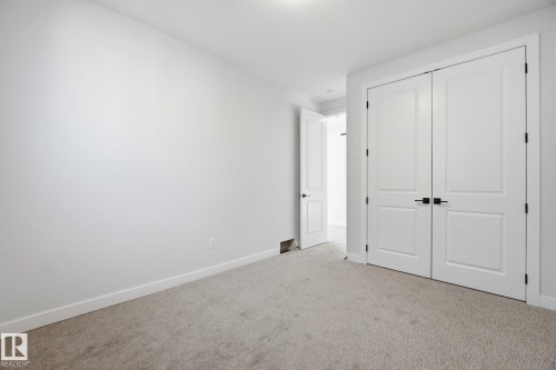 Unfurnished bedroom featuring carpet floors and a closet - 17108 2 Street, Edmonton, AB - Indoor Photo Showing Other Room