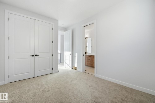 Unfurnished bedroom with light colored carpet, a closet, and ensuite bath - 17108 2 Street, Edmonton, AB - Indoor Photo Showing Other Room