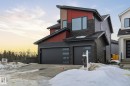 Contemporary home featuring stone siding, board and batten siding, and a garage - 17108 2 Street, Edmonton, AB  - Outdoor 