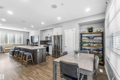 Dining room with dark wood-type flooring and recessed lighting - 1908 25 Street, Edmonton, AB - Indoor