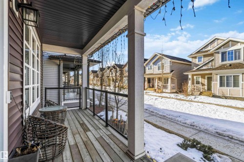 Snow covered deck with a porch and a residential view - 1908 25 Street, Edmonton, AB - Outdoor With Exterior