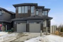 View of front of house with stone siding, roof with shingles, a garage, and driveway - 17107 3 Street, Edmonton, AB  - Outdoor With Facade 