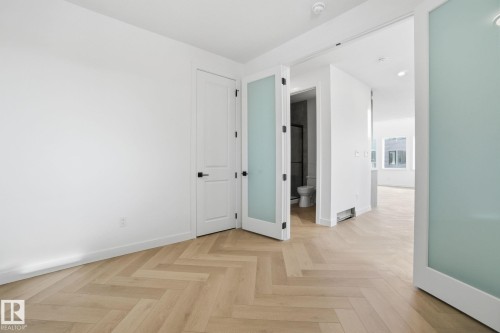 Unfurnished room with parquet floors and baseboards - 17107 3 Street, Edmonton, AB - Indoor Photo Showing Other Room