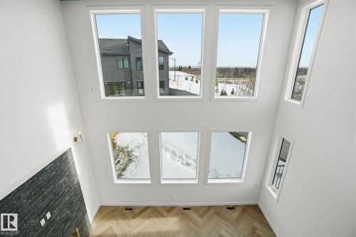 Unfurnished living room featuring a high ceiling and parquet floors - 17107 3 Street, Edmonton, AB - Indoor Photo Showing Other Room