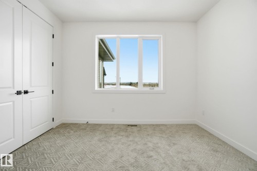 Unfurnished bedroom with a closet and light carpet - 17107 3 Street, Edmonton, AB - Indoor Photo Showing Other Room