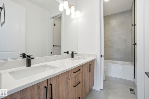 Bathroom featuring finished concrete flooring and double vanity - 17107 3 Street, Edmonton, AB - Indoor Photo Showing Bathroom