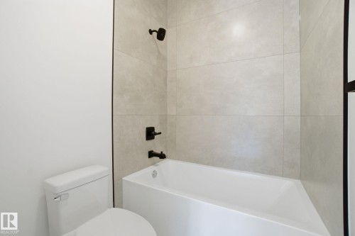 Full bath featuring washtub / shower combination and toilet - 17107 3 Street, Edmonton, AB - Indoor Photo Showing Bathroom