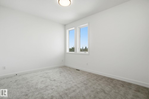Carpeted empty room featuring baseboards - 17107 3 Street, Edmonton, AB - Indoor Photo Showing Other Room