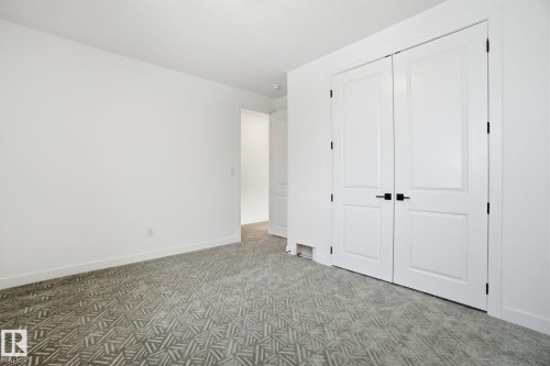 Unfurnished bedroom with light carpet and a closet - 17107 3 Street, Edmonton, AB - Indoor Photo Showing Other Room