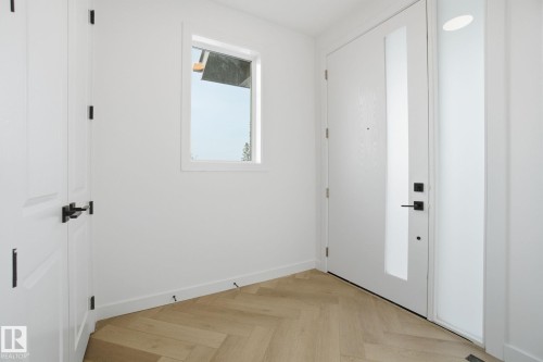 Foyer with parquet flooring and baseboards - 17107 3 Street, Edmonton, AB - Indoor Photo Showing Other Room