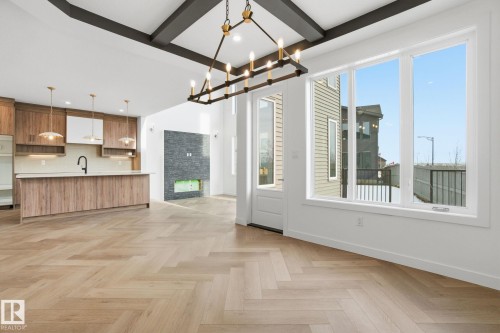 Unfurnished dining area featuring parquet flooring, hanging lights, and beam ceiling - 17107 3 Street, Edmonton, AB - Indoor Photo Showing Kitchen