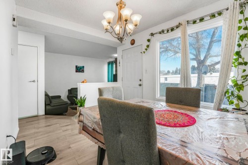 Dining space with suspended lighting and wood finished floors - 19 1415 62 Street, Edmonton, AB - Indoor Photo Showing Dining Room
