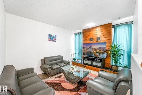 Living area featuring wood finished floors and wooden walls - 19 1415 62 Street, Edmonton, AB - Indoor Photo Showing Living Room