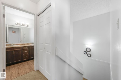 Bathroom with vanity, a textured ceiling, and light wood-type flooring - 19 1415 62 Street, Edmonton, AB - Indoor