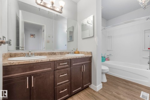 Full bathroom featuring double vanity, shower / bath combination, and light wood-style flooring - 19 1415 62 Street, Edmonton, AB - Indoor Photo Showing Bathroom