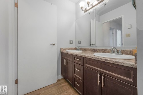 Full bath featuring double vanity and light wood-type flooring - 19 1415 62 Street, Edmonton, AB - Indoor Photo Showing Bathroom