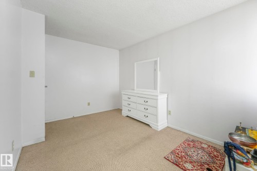Unfurnished bedroom with carpet and a textured ceiling - 19 1415 62 Street, Edmonton, AB - Indoor