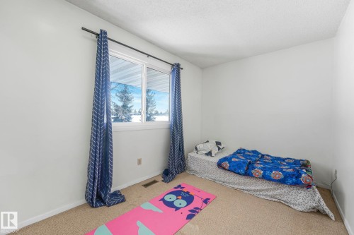 Unfurnished bedroom with carpet flooring and a textured ceiling - 19 1415 62 Street, Edmonton, AB - Indoor Photo Showing Bedroom