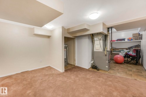 Finished basement featuring heating unit, light carpet, and water heater - 19 1415 62 Street, Edmonton, AB - Indoor