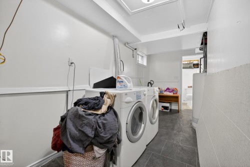 Laundry area with water heater and washer and dryer - 10602 66 Avenue, Edmonton, AB - Indoor Photo Showing Laundry Room
