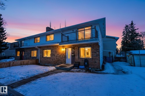 Snow covered rear of property with a chimney, an outdoor structure, a balcony, and brick siding - 10602 66 Avenue, Edmonton, AB - Outdoor
