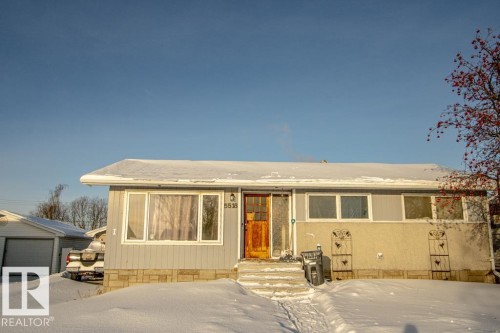 View of front of home with an outdoor structure and a detached garage - 5518 51 Ave, St. Paul Town, AB - Outdoor