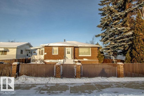 View of front of home with a fenced front yard, brick siding, and a gate - 5130 49 Ave, St. Paul Town, AB - Outdoor
