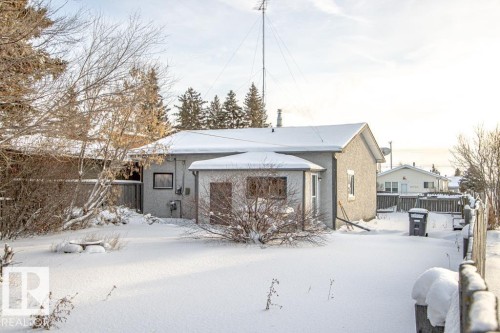 Snow covered back of property featuring stucco siding - 5138 47 Ave, St. Paul Town, AB - Outdoor