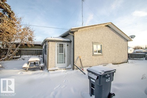 Snow covered rear of property featuring stucco siding - 5138 47 Ave, St. Paul Town, AB - Outdoor With Exterior