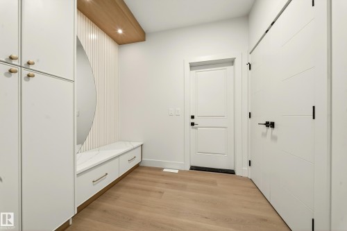 Mudroom with light wood-style floors and recessed lighting - 8924 Mayday Way, Edmonton, AB 