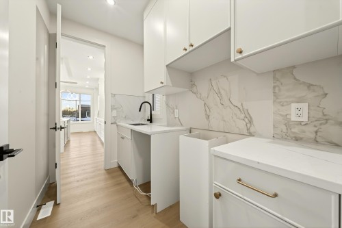 Laundry area with light wood-type flooring and recessed lighting - 8924 Mayday Way, Edmonton, AB 