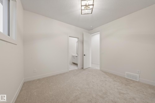 Full bath with vanity, shower / bath combination with glass door, and light marble finish floors - 8924 Mayday Way, Edmonton, AB - Indoor Photo Showing Bathroom