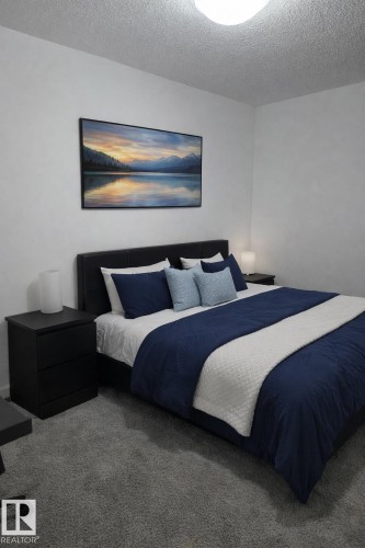 Carpeted bedroom featuring a textured ceiling - 4513 53 Avenue, Wetaskiwin, AB - Indoor Photo Showing Bedroom