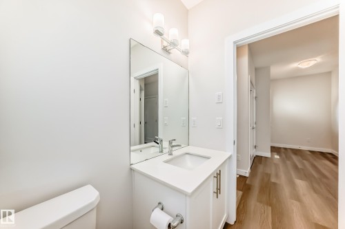 Half bath with vanity and light wood-style flooring - 17926 62A Street, Edmonton, AB - Indoor Photo Showing Bathroom