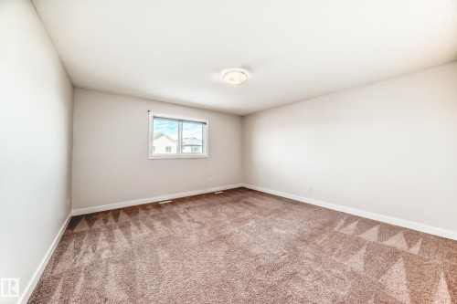 Empty room featuring light colored carpet and baseboards - 17926 62A Street, Edmonton, AB - Indoor Photo Showing Other Room