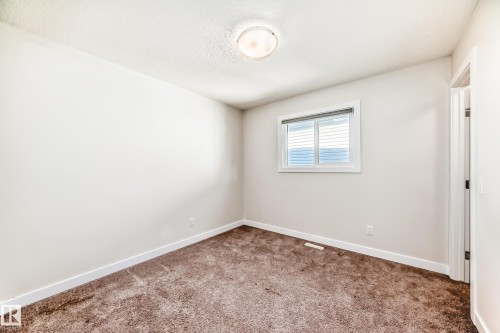 Spare room with carpet floors and a textured ceiling - 17926 62A Street, Edmonton, AB - Indoor Photo Showing Other Room