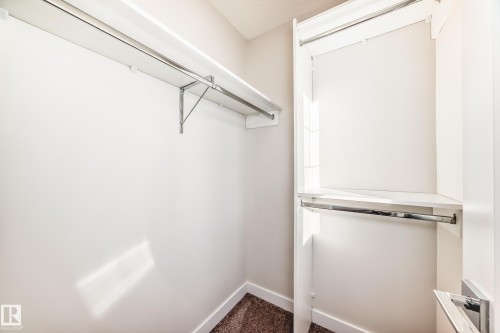 Walk in closet with dark colored carpet - 17926 62A Street, Edmonton, AB - Indoor With Storage