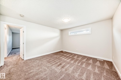 Spare room featuring carpet floors and a textured ceiling - 17926 62A Street, Edmonton, AB - Indoor Photo Showing Other Room