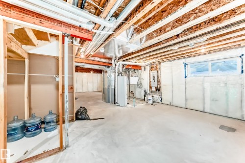 Basement featuring water heater, heating unit, and electric panel - 17926 62A Street, Edmonton, AB - Indoor Photo Showing Basement