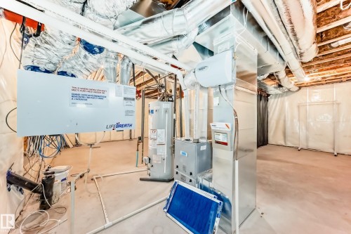 Utility room featuring gas water heater and heating unit - 17926 62A Street, Edmonton, AB - Indoor Photo Showing Basement