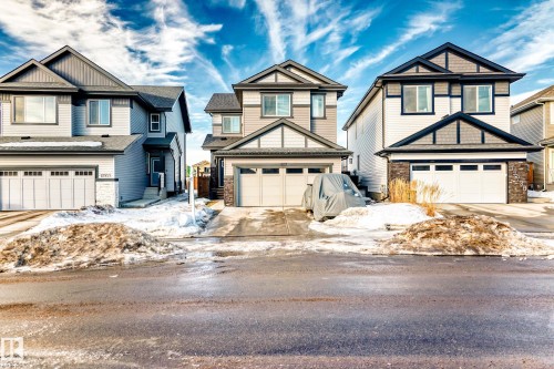 Craftsman inspired home with driveway, an attached garage, and stone siding - 17926 62A Street, Edmonton, AB - Outdoor With Facade