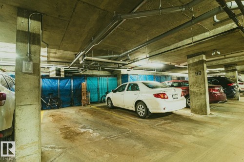 Heated, titled, and secure parkade including a full size storage locker. Stall 98 - 301 625 Leger Way Nw, Edmonton, AB - Indoor Photo Showing Garage