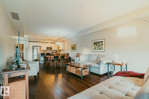 Great room area featuring real 3/4' hand scraped hardwood flooring. - 301 625 Leger Way Nw, Edmonton, AB - Indoor Photo Showing Living Room