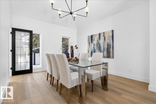 Dining room featuring light wood-type flooring and suspended lighting - 218 Omand Drive, Edmonton, AB 