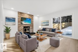 Living area featuring light wood finished floors, a fireplace, and recessed lighting - 